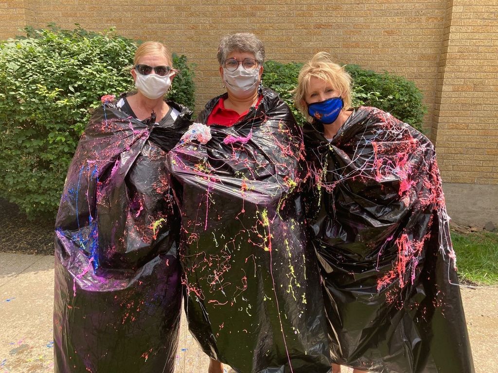 teachers covered in colored string
