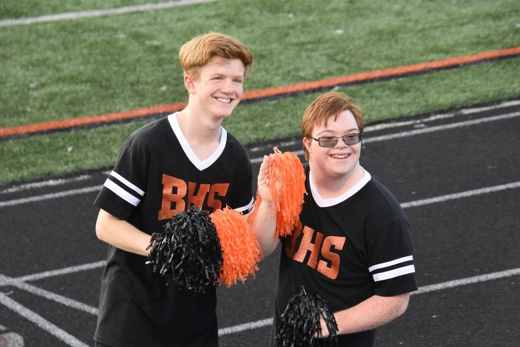 Two students pose on track