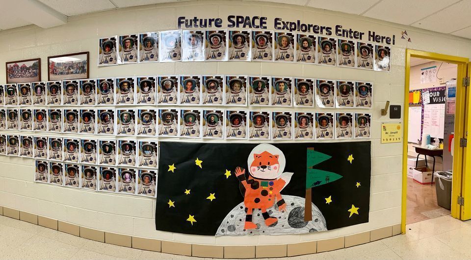 Wall showcasing photos of students dressed as astronauts