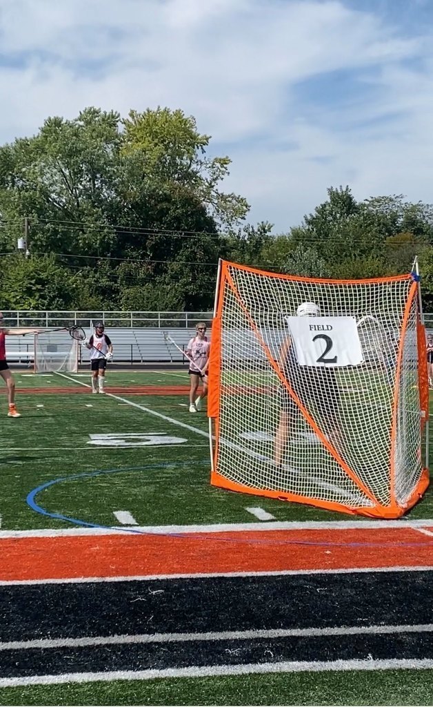 Female lacrosse players run on field