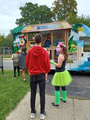 Students in costume line up for shaved ice