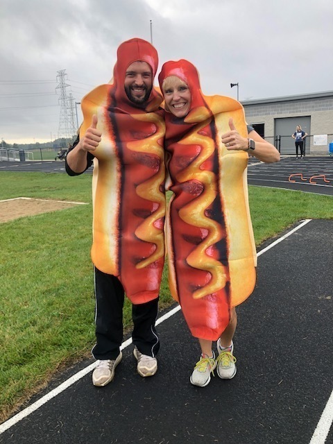 Teachers in hot dog costumes give thumbs-up