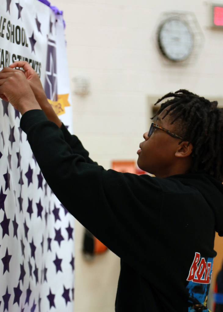 student placing star on banner to represent themselves as one of our military students