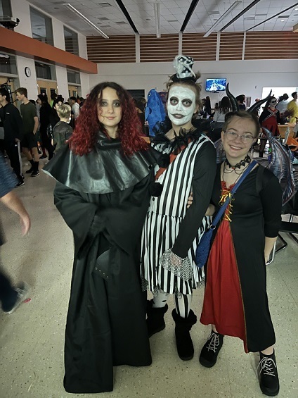 Three friends dressed up as the grim reaper, black and white clown and a vampire